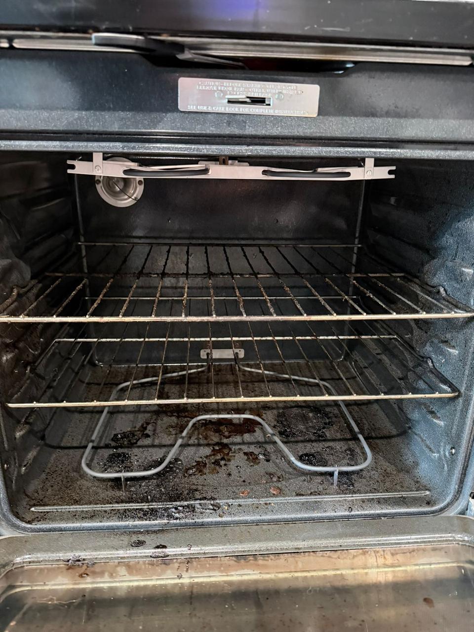 Oven interior with baked-on grease and burnt residue before cleaning