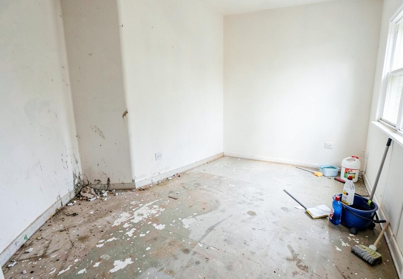 Empty room showing dusty neglected areas next to a freshly cleaned section